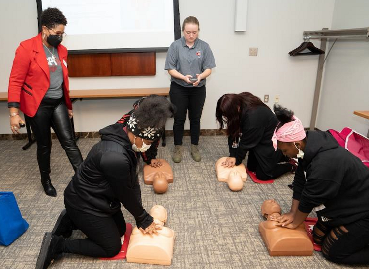 Four girls learning CPR